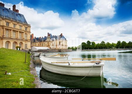 Wooden boat in the pond of French king royal Fontainebleau palace, France Stock Photo