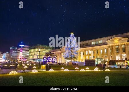 Illuminated Christmas tree and market fair on Castle square or Schlossplatz in German, Stuttgart Stock Photo