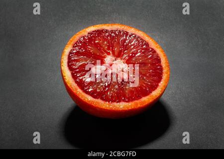 sliced blood tangerine on black background Stock Photo