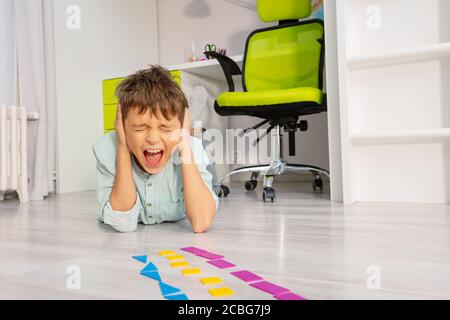 Autistic boy with educational exercise development geometric shapes ...