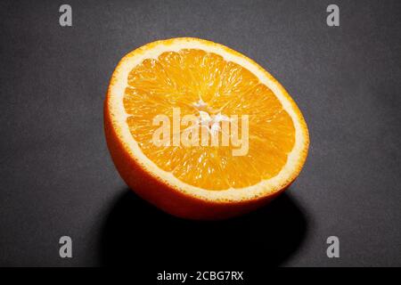 sliced orange fruit on black background Stock Photo