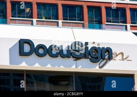 DocuSign sign and logo on facade of company headquarters building. DocuSign, Inc.allows organizations to manage electronic agreements. - San Francisco Stock Photo