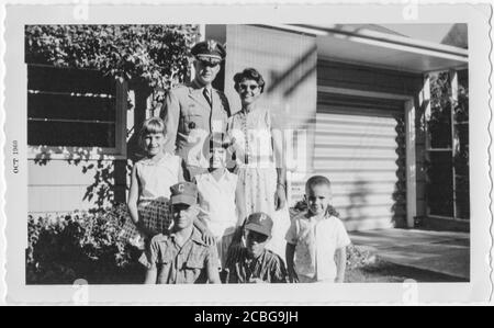 Large military family posing in front of their home, 1960, Atlanta, Georgia, USA Stock Photo