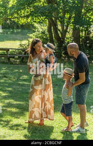 French family hiking in the forest together on new normal vacation Stock Photo