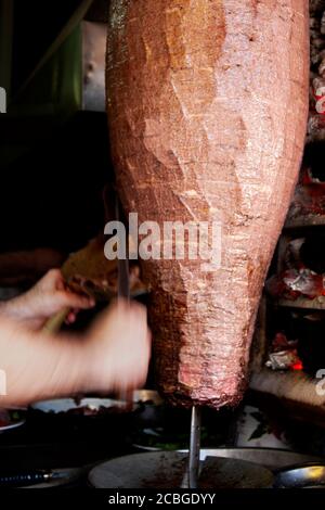 Traditional Turkish dish that is eaten throughout Turkey Food.Turnspit skewing kebap or kebab on metal skewer in the kebab restaurant Stock Photo