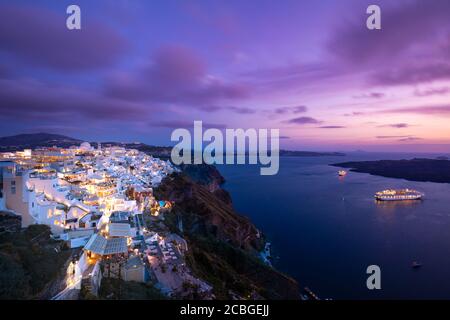 Romantic Santorini island during sunset, Greece, Europe. Romantic couple destination cruise ships amazing sunset sky city lights. Amazing landscape Stock Photo