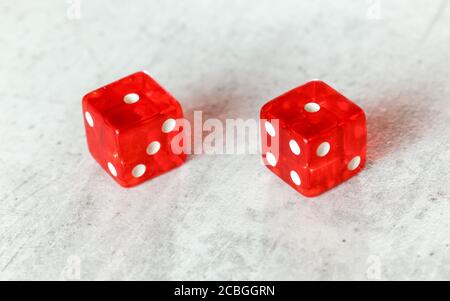 Two translucent red craps dices on white board showing Snake Eyes (Double number 1) Stock Photo