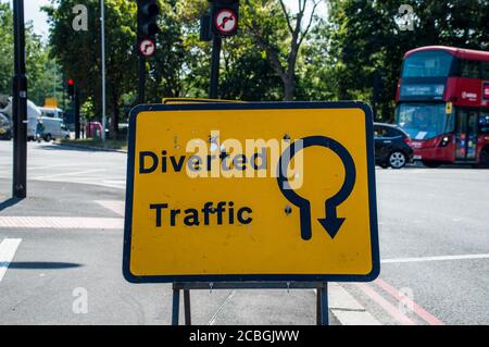 Diverted Traffic sign board to go around in round about Stock Photo