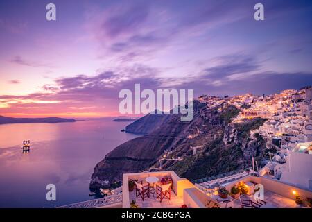 Amazing landscape evening view of Fira, caldera, volcano of Santorini, Greece with cruise ships at sunset. Travel destination cloudy dramatic sky. Stock Photo