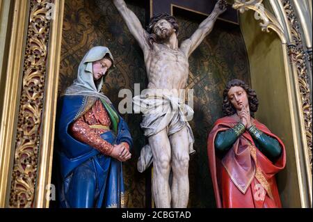The Crucifixion – Sculpture of Jesus Christ on the cross with the Virgin Mary and Saint John beside Him. St Martin's Cathedral in Bratislava, Slovakia. Stock Photo