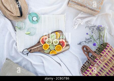 Luxury summer picnic flatlay in the park with citrus fruits Stock Photo