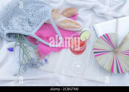Glass of rose wine at a luxury, romantic, flat lay picnic set up on a summer day in the park