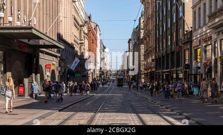 Aleksanterinkatu -street is part of tourism hotspot in Helsinki. City is waking to life after coronavirus lockdown and more people walk the streets. Stock Photo