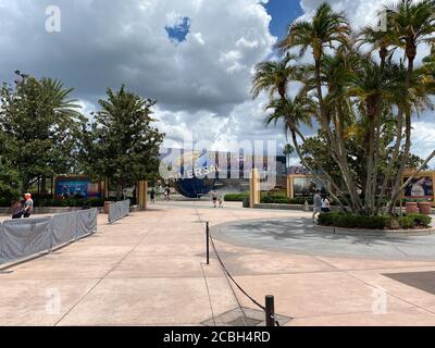 Orlando,FL/USA- 6/13/20: People walking around the nearly empty Universal Studios  in Orlando, Florida while wearing face masks and social distancing. Stock Photo