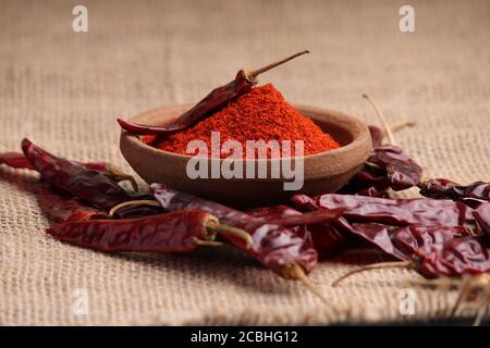red chilli powder with dried red chillies. in earthen bowl. Stock Photo