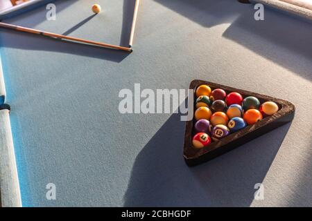 Billiard balls in a pool table in abstract light. Billiard balls in a green pool table, game. Billiard table with cue and balls. Snooker billiard game Stock Photo