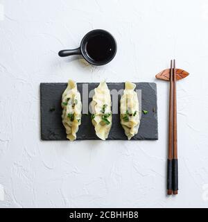 Japanese gyoza or dumplings snack with soy sauce Asian food on white background top view Stock Photo