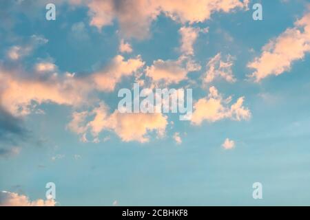 Pink clouds against a blue sky at sunset. Stock Photo