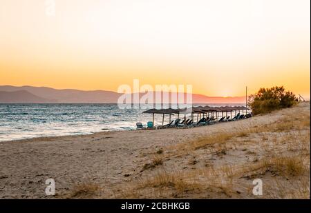 Scenic sunset in Plaka beach in Naxos island, Cyclades, Greece. Stock Photo