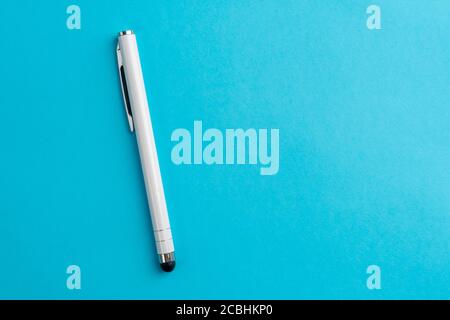 Capacitive touchscreen stylus on blue background. Copyspace. Closeup Stock Photo