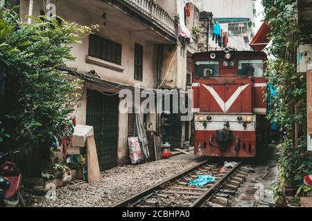 Landmark of Hanoi: Close up of old train running on railway in the afternoon at Hanoi, Vietnam - Transport of Hanoi Stock Photo