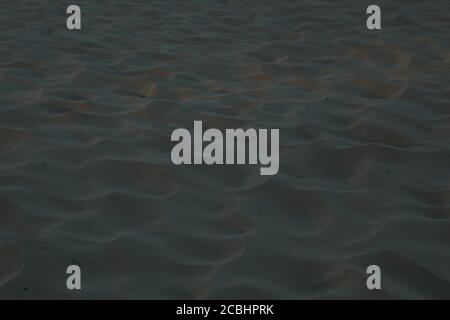 sand uneven waves highlighted by the sun sand background on the sea river lake summer Stock Photo