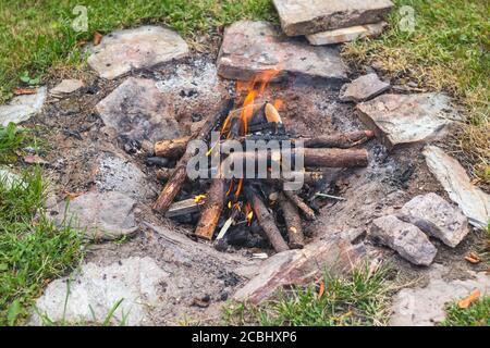 camp fire in the garden, stones around, in summer day Stock Photo