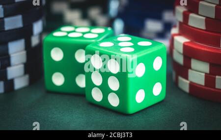Playing dice and poker chips stacks, close up view Stock Photo
