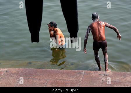 two unidentified adult men bathing at ganges river near assi ghat at varanasi uttar pradesh india. Stock Photo
