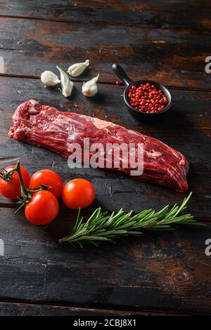 Machete steak raw cut or hanging tende cut, with rosemary over wood background Top side view Stock Photo