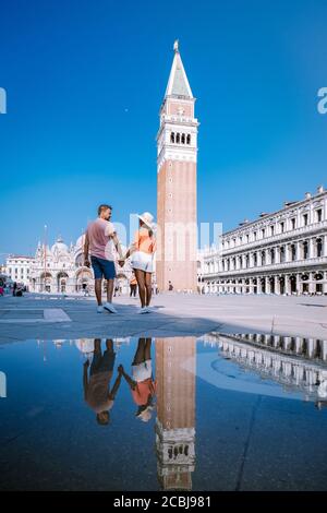 couple men and woman on a city trip to Venice Italy, colorful streets with canals Venice Stock Photo
