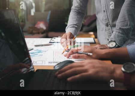 UX or UI designers designing on their smartphone application layout prototype project. Stock Photo