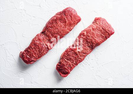 Raw set of denver steak on a white stone background top view Stock Photo