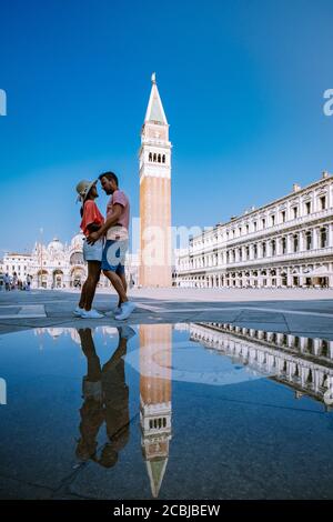 couple men and woman on a city trip to Venice Italy, colorful streets with canals Venice Stock Photo