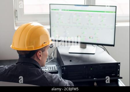 Maintenance engineer inspect relay protection system with laptop
