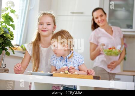 Happy family having breakfast and two children eating eggs Stock Photo