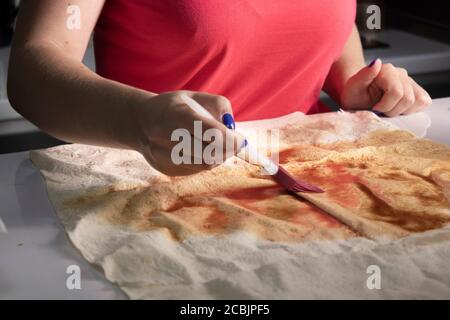 girl's hands prepare pita bread in a gray kitchen on a white table top. cooking process. High quality photo Stock Photo
