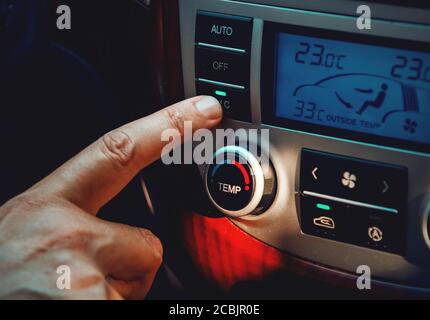 Close up of a man activating Air Conditioner in a modern SUV Stock Photo