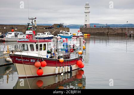 Newhaven Harbour, Edinburgh, Scotland, UK. 14 August 2020. Temperature 17 degrees and thick cloudy  weather as the Kayileigh Ann fishing boat tied up in the small harbour in the Firth of Forth with the lighthouse in the background. Stock Photo