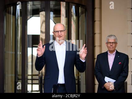 14 August 2020, Brandenburg, Potsdam: Dietmar Woidke (l, SPD), Minister President of Brandenburg, speaks at the beginning of his press tour in front of the entrance to the Barberini Museum next to Dieter Hütte, Managing Director Tourism Marketing Brandenburg. During the closing phase of the museum, there was a preview of the new exhibition 'Impressionism. The Hasso Plattner Collection', which will open on 07.09.2020. Potsdam should thus become one of the most important centres of collections of impressionist landscape painting worldwide outside of Paris. Photo: Soeren Stache/dpa-Zentralbild/ZB Stock Photo