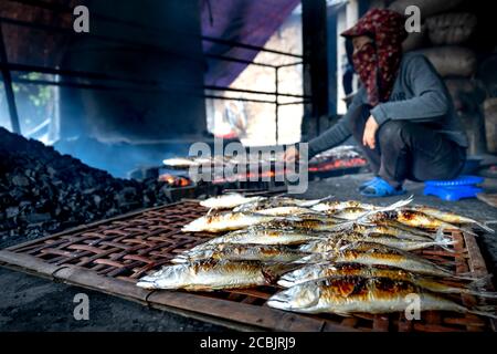 The image of fresh fish of fishermen grilled on embers for sale at the market at Dien Van grilled fish village, Nghe An province, Vietnam Stock Photo