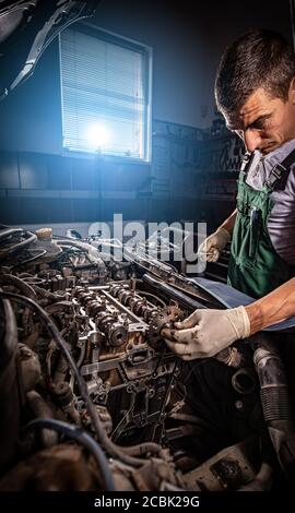 Mechanic in uniform is working Stock Photo
