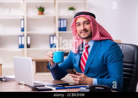 Young male arab employee working in the office Stock Photo