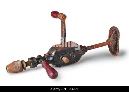 Old and rusty vintage drill hand operated isolated on white Stock Photo