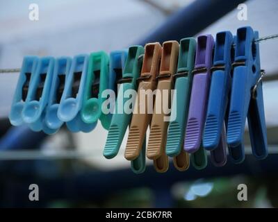 colored clothespins on the rope close-up Stock Photo