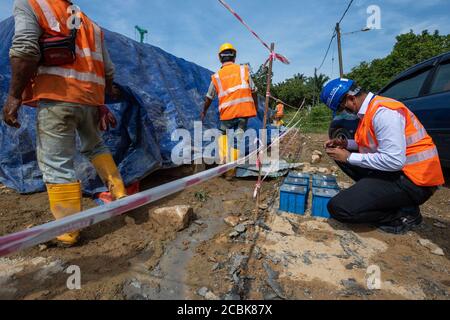 Kuala Lumpur, Malaysia. 12th Aug, 2020. Hakimi Razak (R), a QAQC manager for China Communications Construction Company (CCCC), works at a bridge construction site of the East Coast Rail Link (ECRL) in Pahang state, Malaysia, Aug. 12, 2020. TO GO WITH: 'Feature: Constructions of Malaysia's railway megaproject ECRL back to full swing with strong precautions measures against COVID-19' Credit: Zhu Wei/Xinhua/Alamy Live News Stock Photo