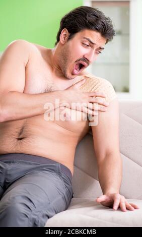 The man applying pepper capsicum plaster to relieve pain Stock Photo