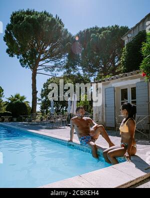 couple relaxing by the pool in the Provence France, men and woman relaxing by pool at luxury resort