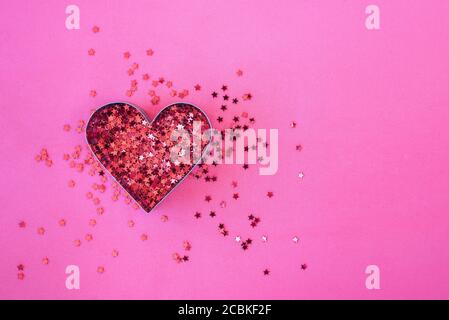 Heart shaped red sparkles on pink background. Love, Valentines day Stock Photo