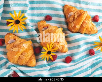 Yummy freshly three croissants with raspberries, view from above Stock Photo